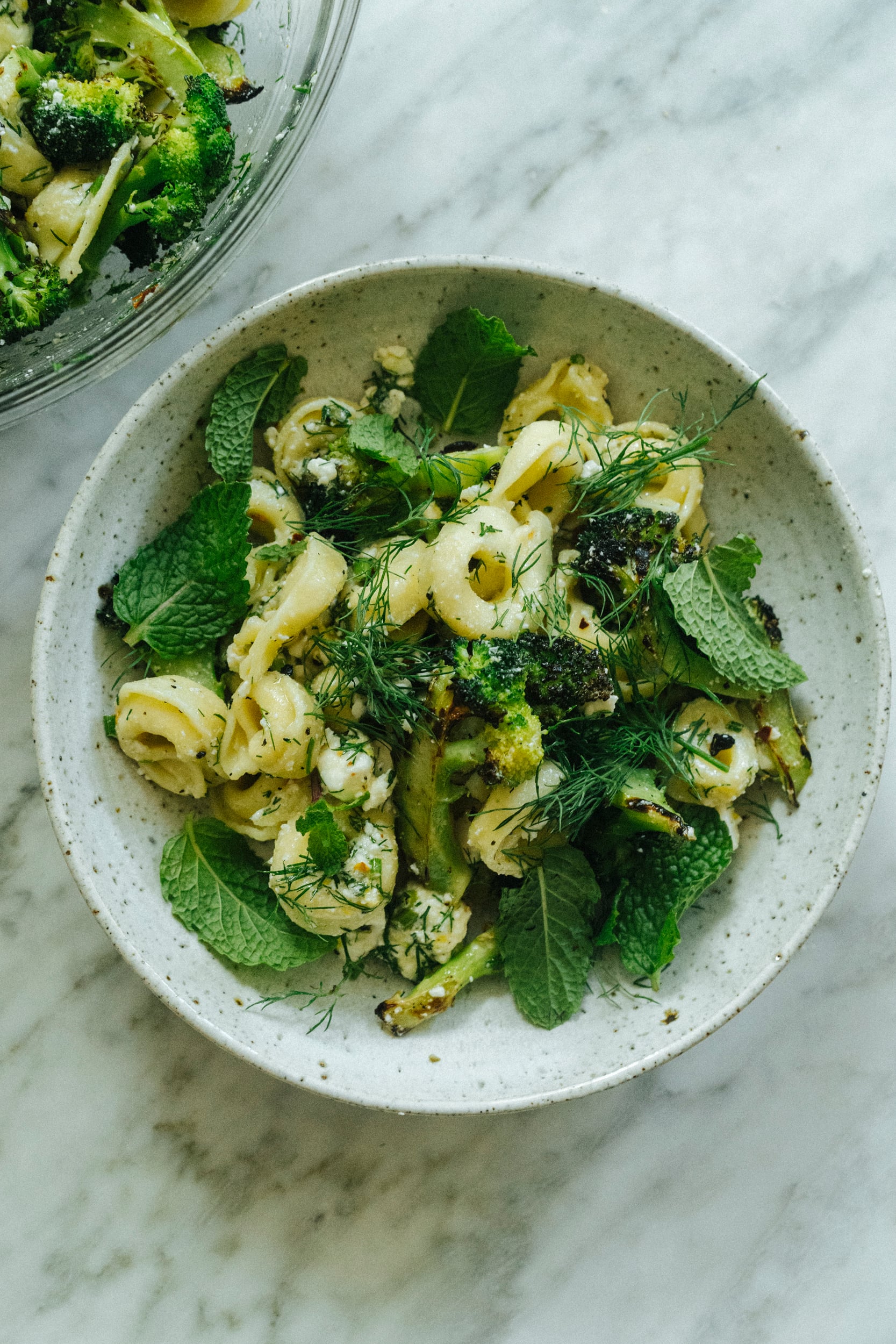 A bowl of orecchiette pasta with roasted broccoli, crumbled cheese, fresh mint, and dill. - Hetty Lui McKinnon