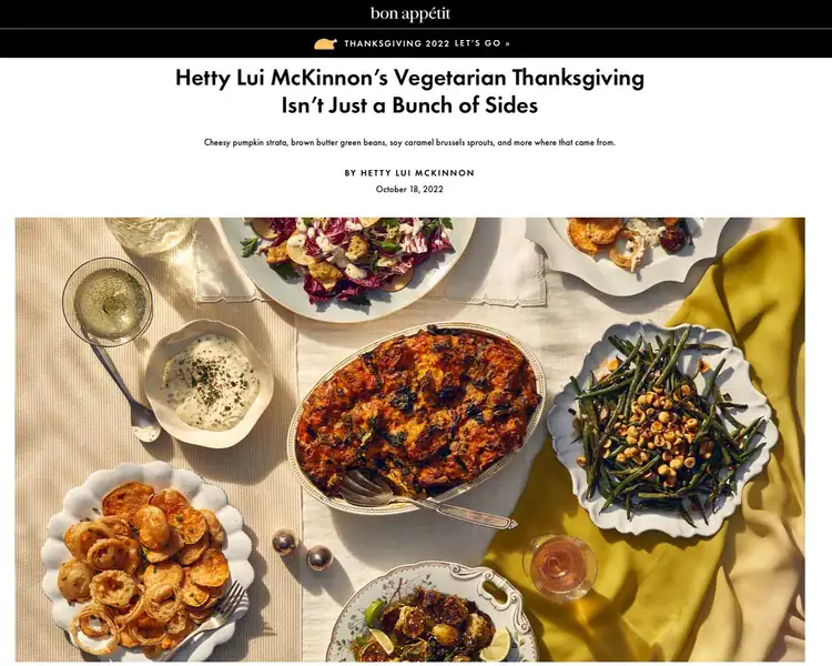 A table set with various vegetarian Thanksgiving dishes, including green beans, cheesy pumpkin, baked casserole, potatoes, and salad, under warm sunlight.